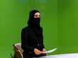 Die afghanische Fernsehjournalistin Lema Spasli moderiert für den privaten Sender 1 TV vor einem Greenscreen - auf Anordnung der Taliban verhüllt.