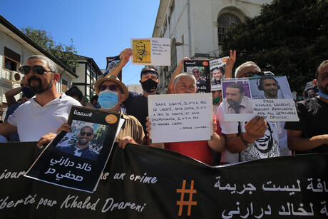 Demonstrierende halten nach der Verhaftung Khaled Drarenis Plakate von ihm hoch