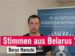 Belarusischer Journalist vor Plakat