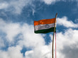 Die indische Nationalflagge (oranger, weißer und grüner Querbalken; in der Mitte ein blaues Kreissymbol) weht vor dem Himmel