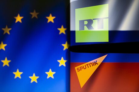 Die EU will die beiden russischen Sender RT und Sputnik verbieten. Zu sehen sind die EU-Flagge sowie die Logos der beiden Sender auf einer russischen Flagge. © picture alliance / ZUMAPRESS.com / Andre M. Chang